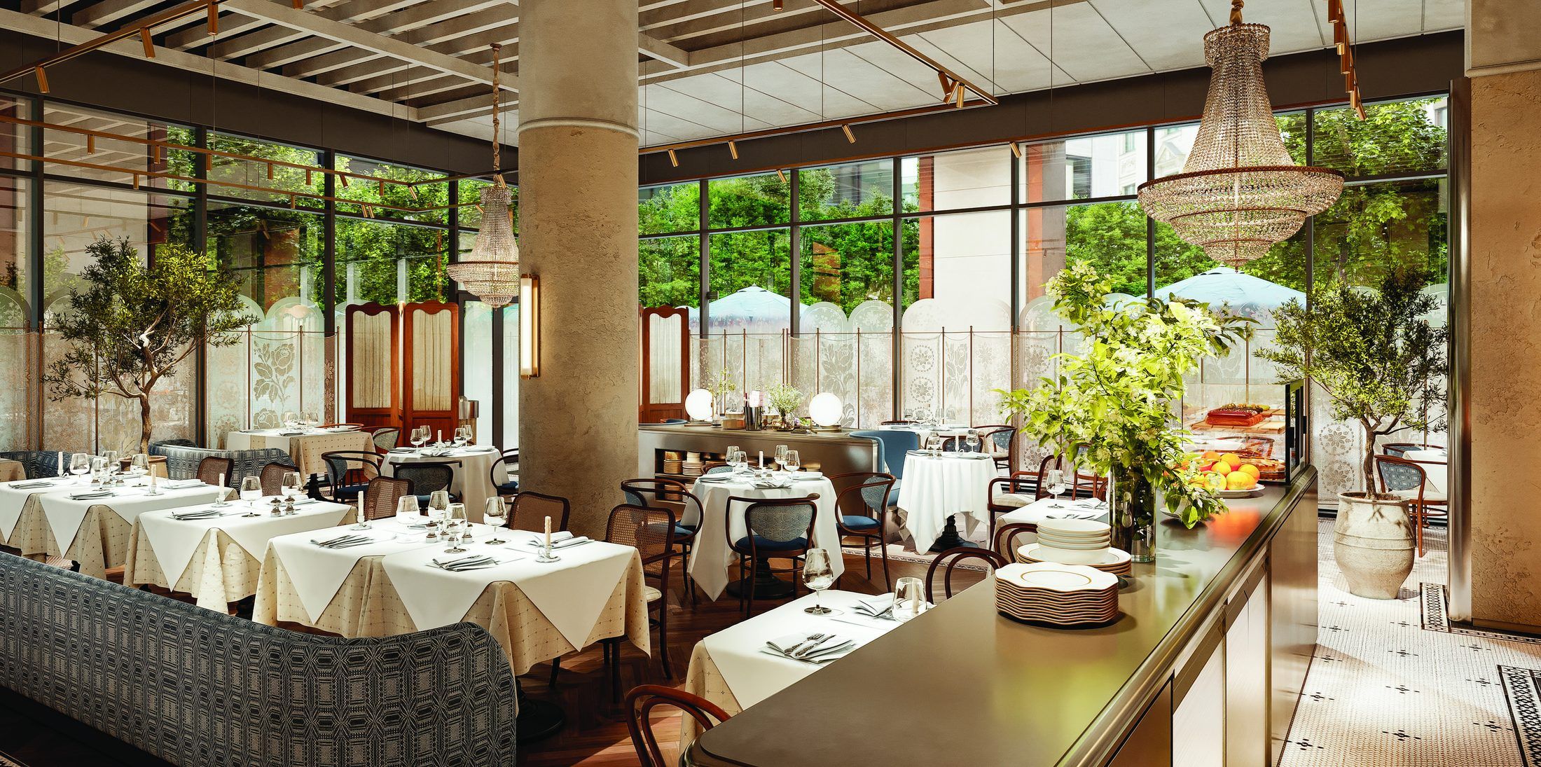 The dining room: white tablecloths, bentwood chairs, a crystal chandelier and the open counter